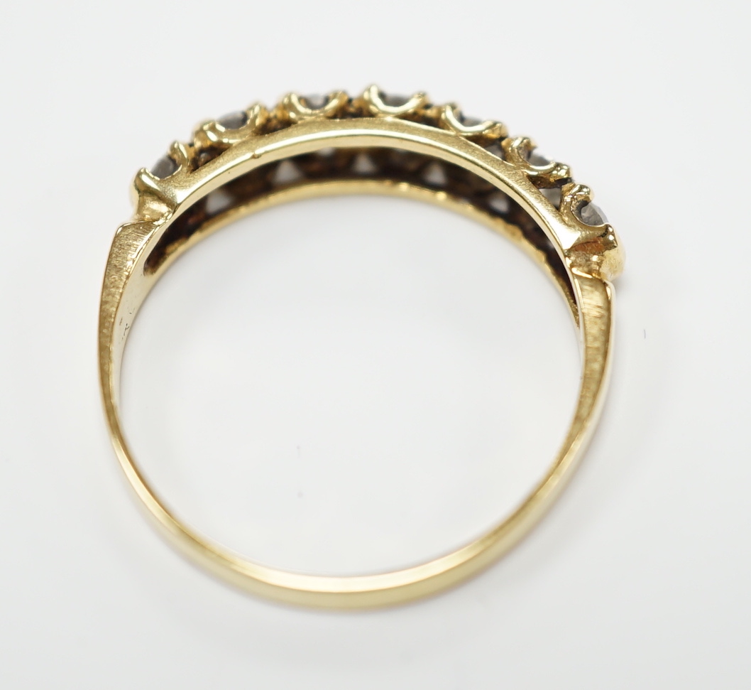 An 18ct gold and seven stone diamond set half hoop ring, size P, gross weight 2.7 grams.